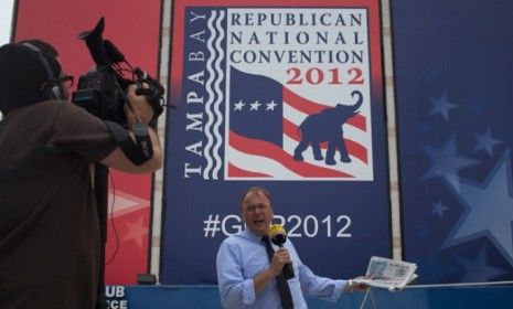 A journalist outside the site of the Republican National Convention in Tampa on Aug. 27: Tropical Storm Isaac is likely to steer clear of the big GOP event â€” but it could hit New Orleans.