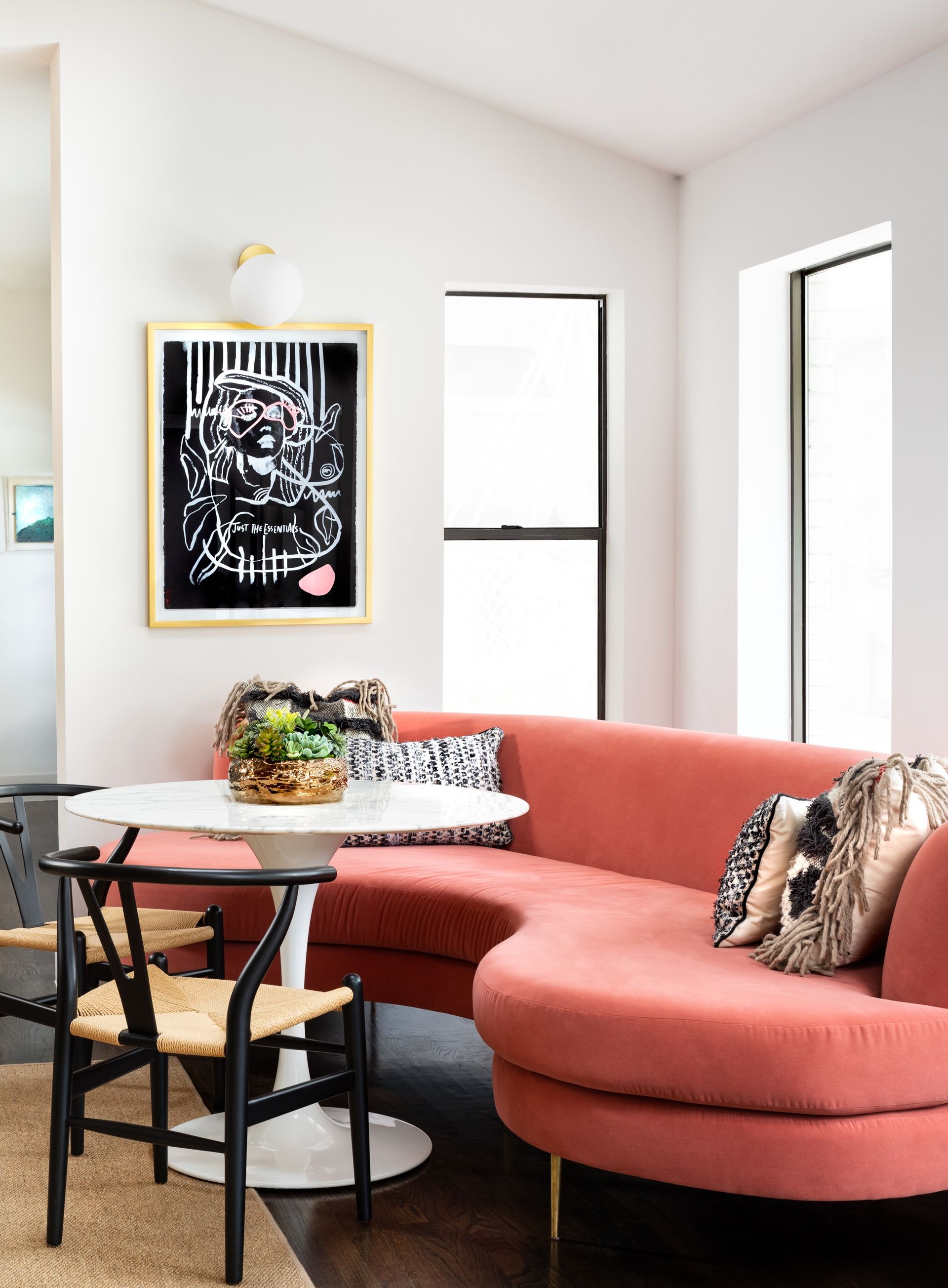 dining area with red curved sofa by Maestri Studio