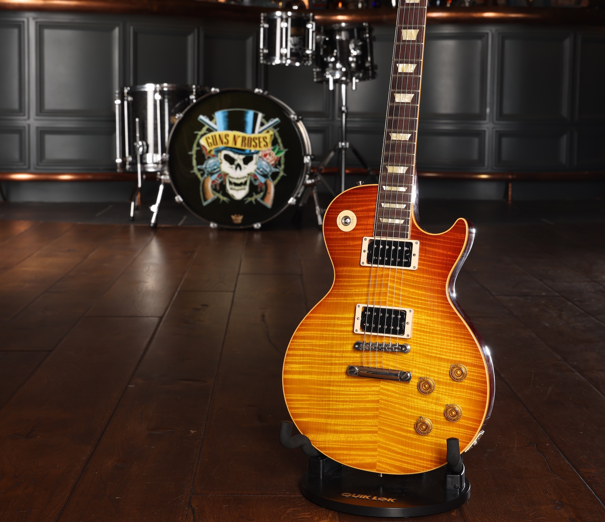 A Slash-played and -signed Gibson Les Paul &amp;lsquo;59 Custom Shop guitar, sat on a stand on a hardwood floor