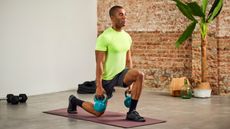 a man performing a kettlebell lunge