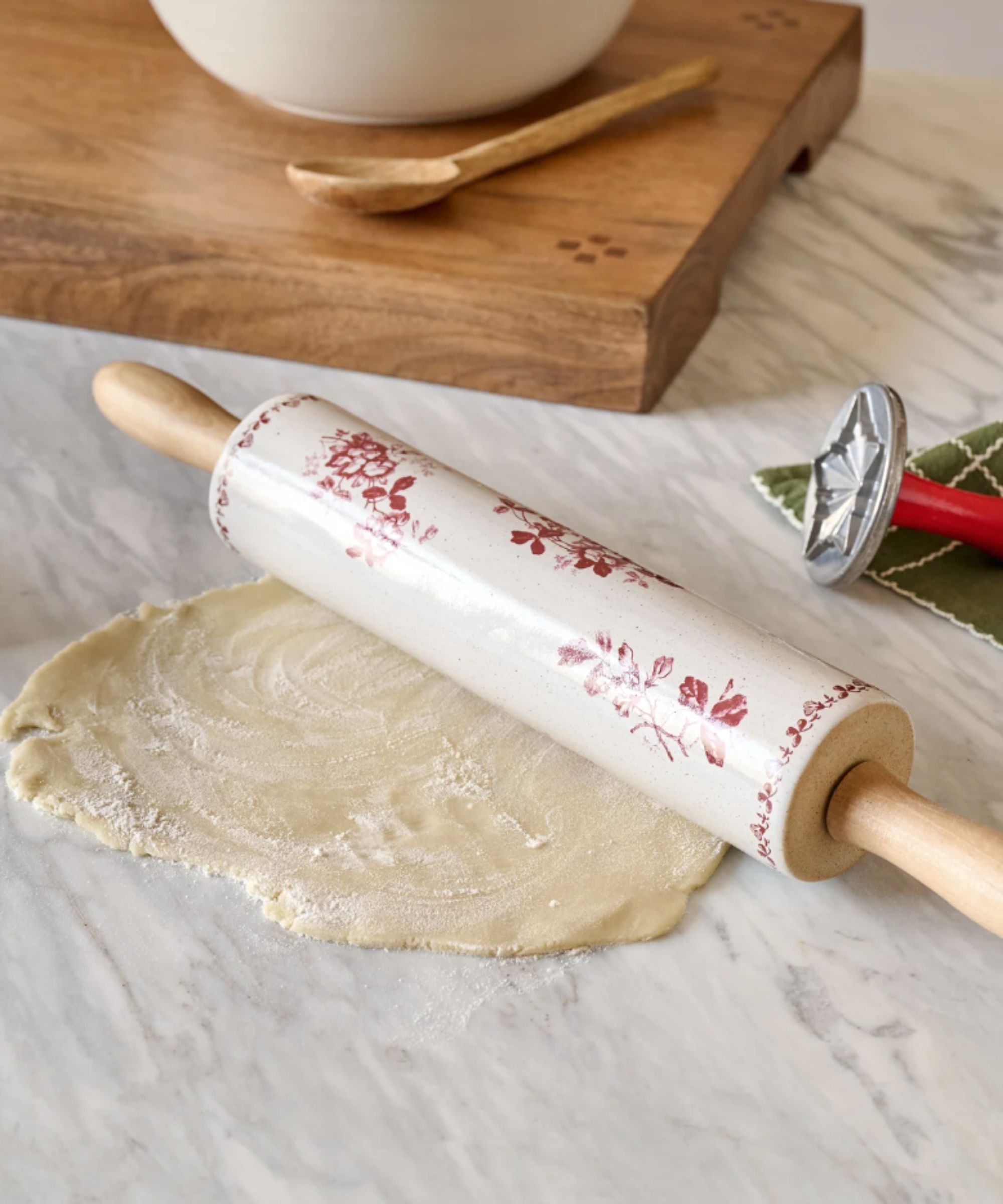White ceramic rolling pin with red floral design