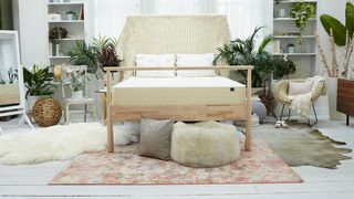 WinkBeds mattress sales, deals and discounts: The WinkBed EcoCloud Hybrid Mattress sat on a light wooden bed frame with a faux fur ben bag at the base of the bed