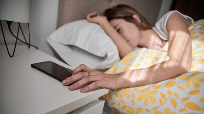 Young woman switches off alarm