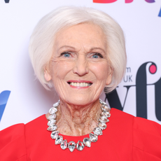 Mary Berry in red dress and diamond necklace.