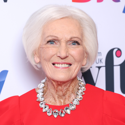 Mary Berry in red dress and diamond necklace.