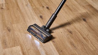 A black and gold Dreame R10 Pro cordless vacuum cleaner