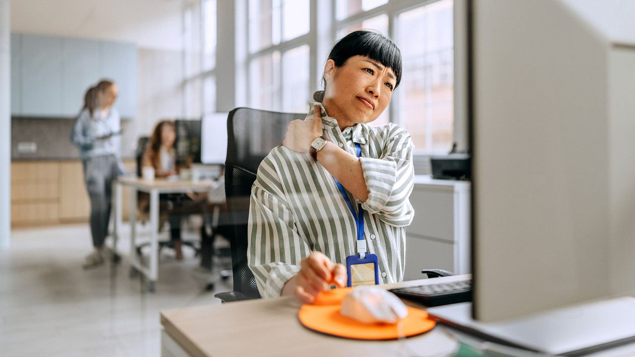 Businesswoman having neck ache due to work over load and bad posture