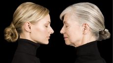 A young woman faces an older woman. Both have their eyes closed.