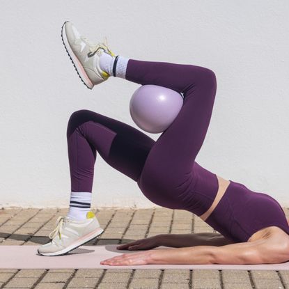 Micro workouts: A woman working out with a Pilates ball