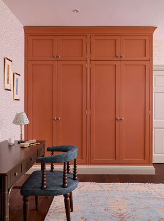 Pink bedroom with orange closet