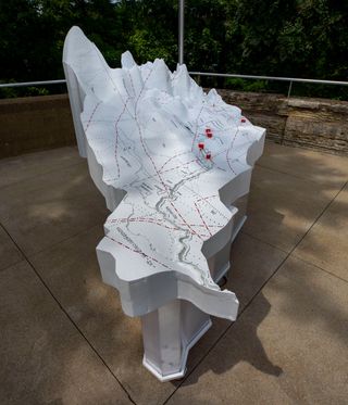 Tracing Our Mississippi, Derek Hoeferlin 2021. A white stone outdoor structure with a map of the Mississippi on it.