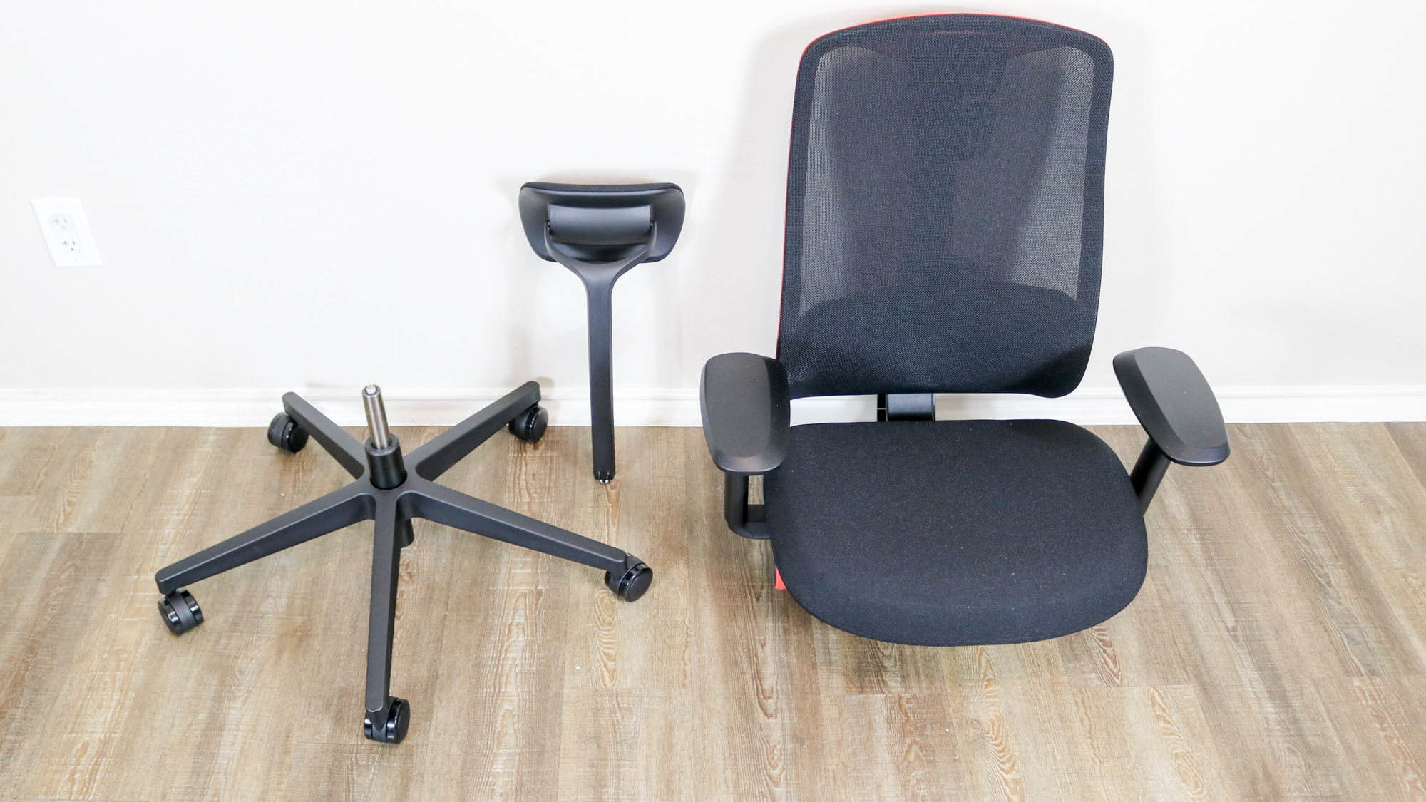 The Vantum Gaming Chair unboxed with the base, headrest and chair on the floor