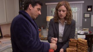 Pam taking the whisk from Michael near a stack of french toast