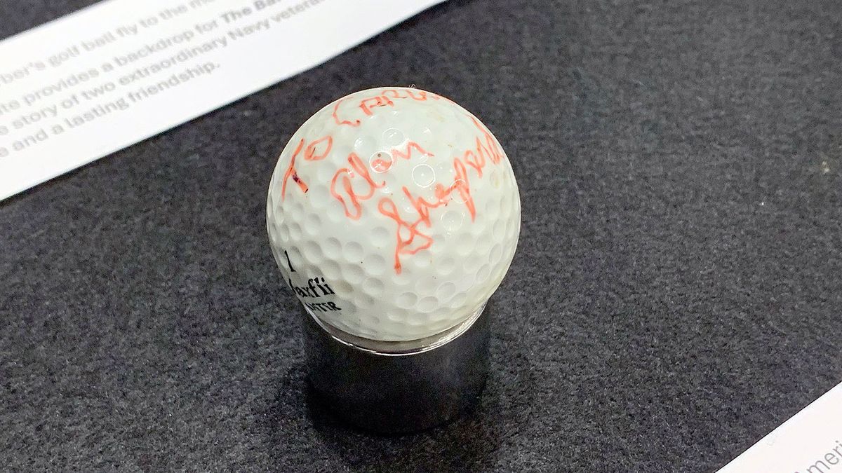 an golf ball autographed in orange ink