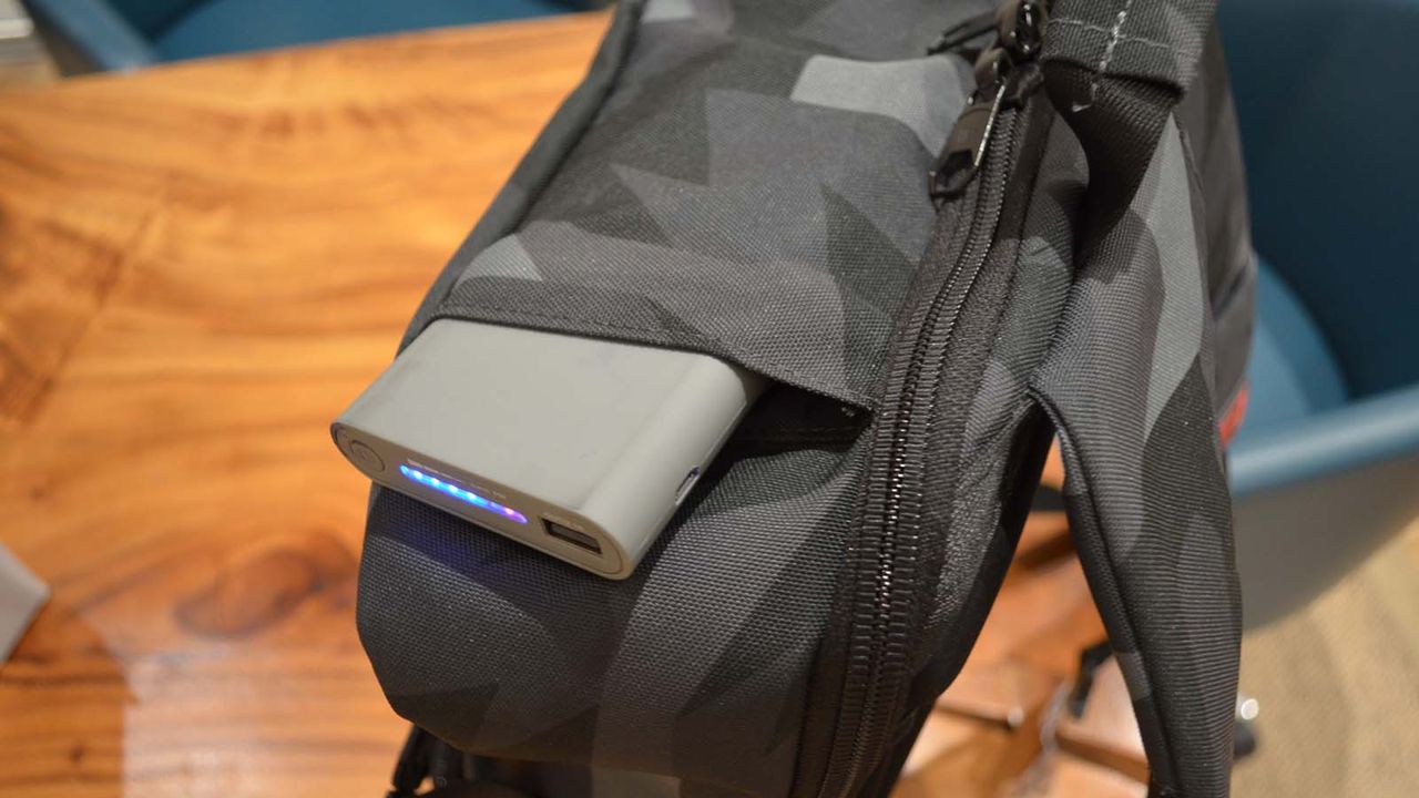 A Hex Technical Backpack on a wood grain table