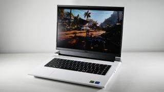 Dell G16 (7630) open on a white table at an angle with Far Cry 6 on screen.