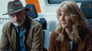 Sam Neill and Laura Dern sitting on the hyperloop train in Jurassic World Dominion.