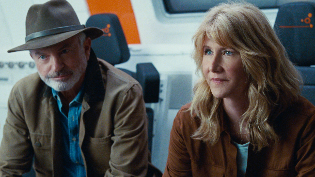Sam Neill and Laura Dern sitting on the hyperloop train in Jurassic World Dominion.
