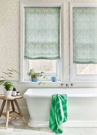 bathroom with white bath and green and white blinds