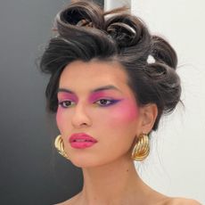 Model wearing colorful editorial makeup.