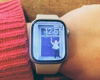 Apple Watch Series 8 showing wallpaper on writer's wrist