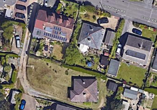 The former bungalow can be seen at the bottom of this image
