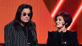 Ozzy and Sharon Osbourne onstage at an awards ceremony