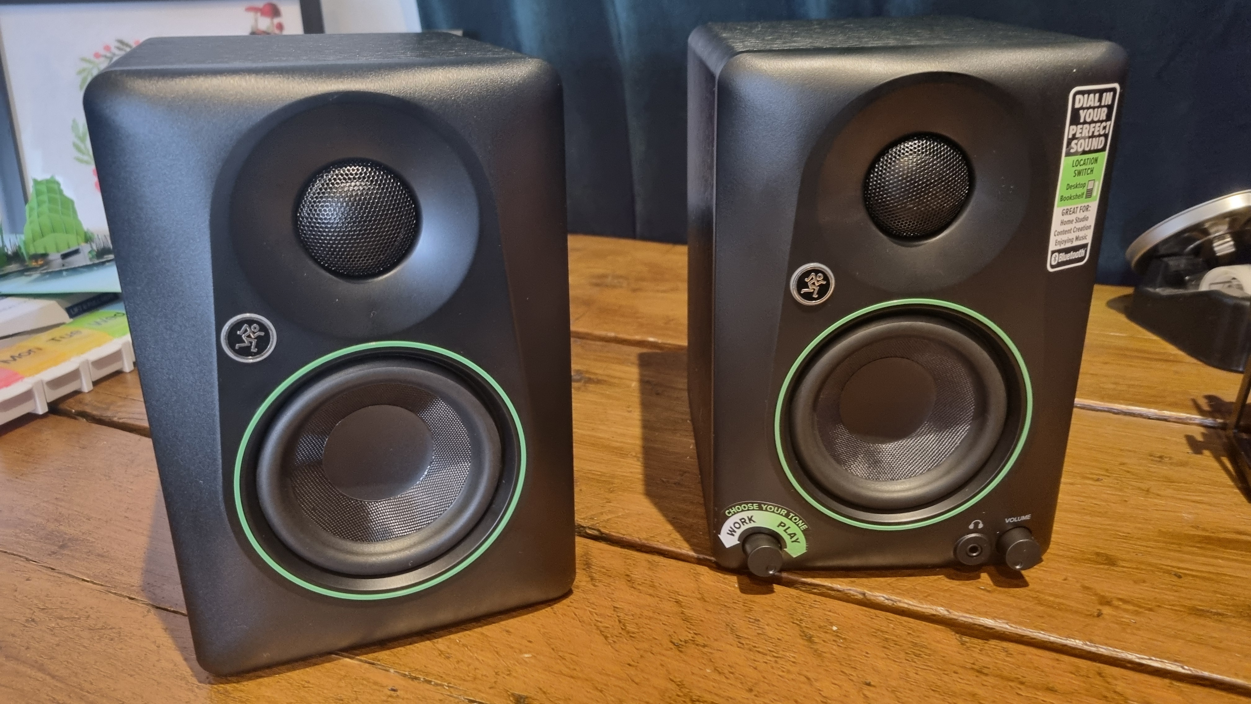 Two Mackie CR3.5BT reference speakers on a wooden table