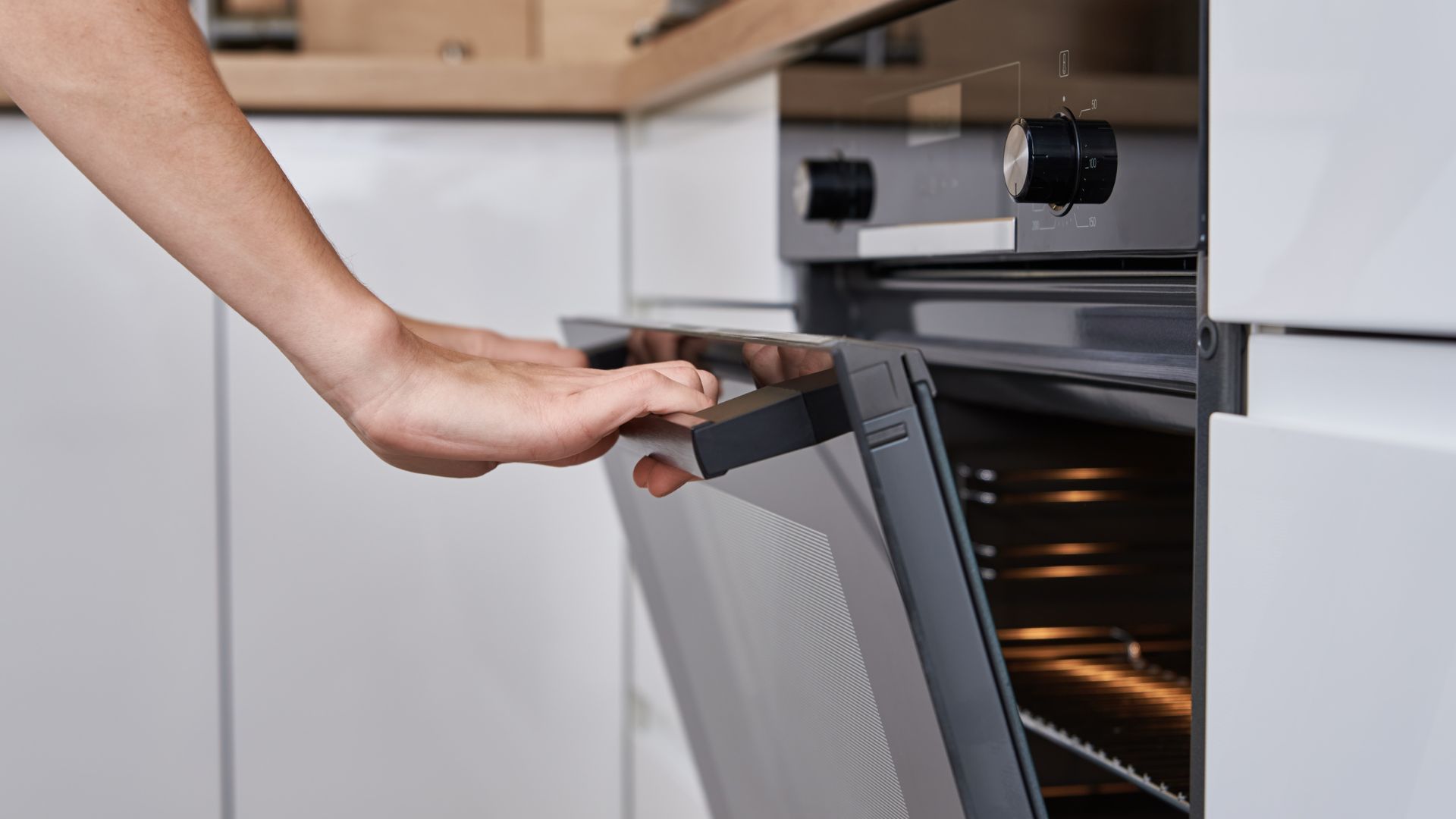picture of woman opening oven door