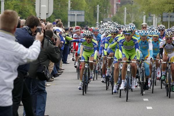 A Liquigas rider makes his feelings known as the crowd leans out for a snapshot of the peloton