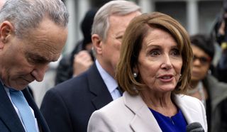 Speaker of the House Nancy Pelosi, accompanied by Senate Minority Leader Chuck Schumer, addresses reporters outside the U.S. Capitol.