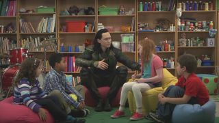 Tom Hiddleston pushes a young girl among a circle of kids in Thor: The Dark World.