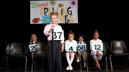 Kids compete in a spelling bee.