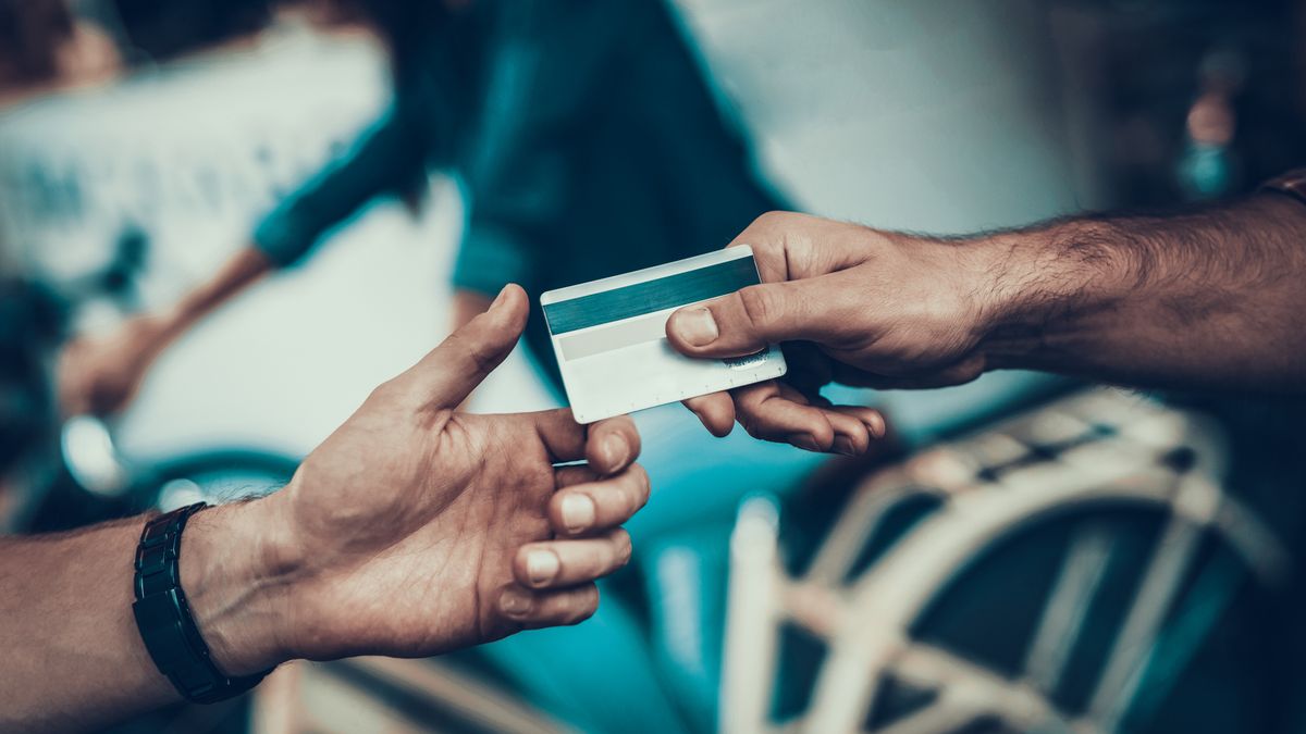 Close up of someone handing over a credit card