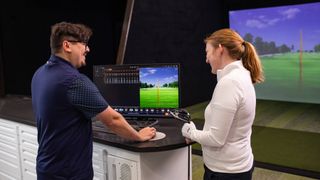 Female golfer being shown data