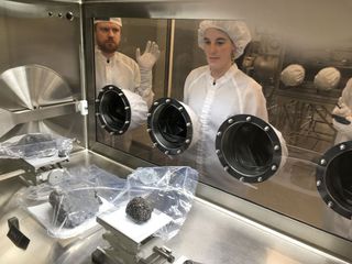 Sara Arsenault (center) of the Montreal Science Centre looks at some moon rocks at NASA's Johnson Space Center in Houston.