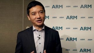 Allen Wu in front of ARM sign. 