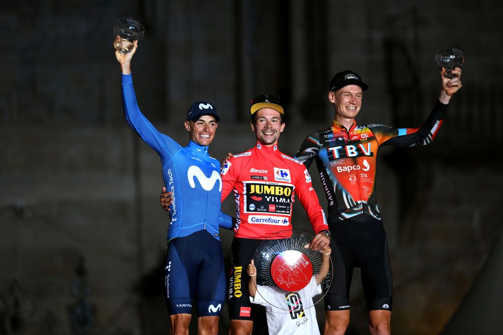 SANTIAGO DE COMPOSTELA SPAIN SEPTEMBER 05 A general view of Enric Mas Nicolau of Spain and Movistar Team Primoz Roglic of Slovenia and Team Jumbo Visma red leader jersey his son Levom and Jack Haig of Australia and Team Bahrain Victorious celebrate winning on the podium ceremony in the Plaza del Obradoiro after during the 76th Tour of Spain 2021 Stage 21 a 338 km Individual Time Trial stage from Padrn to Santiago de Compostela lavuelta LaVuelta21 ITT on September 05 2021 in Santiago de Compostela Spain Photo by Tim de WaeleGetty Images