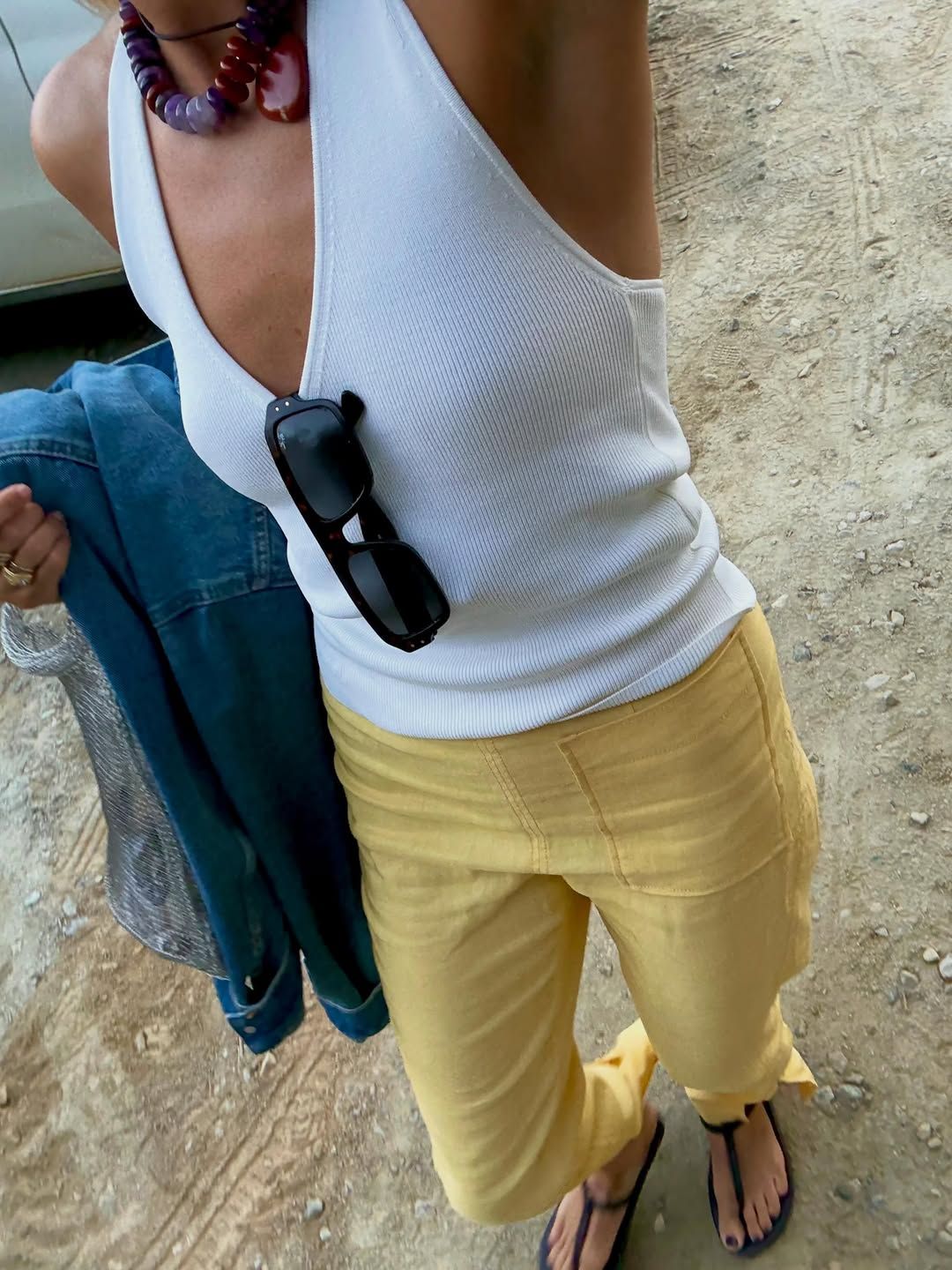 Influencer Lucy Williams wearing cropped jeans and a halterneck top.