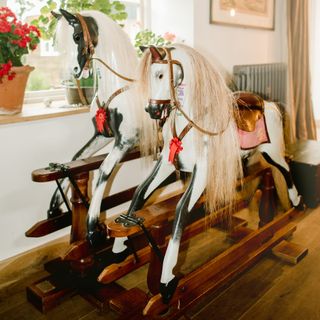 A living room with carousel horses as decor