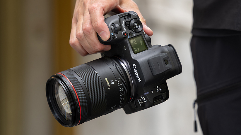 Canon RF 85mm f/1.4L VCM on a Canon EOS R5 Mark II being held by a photographer