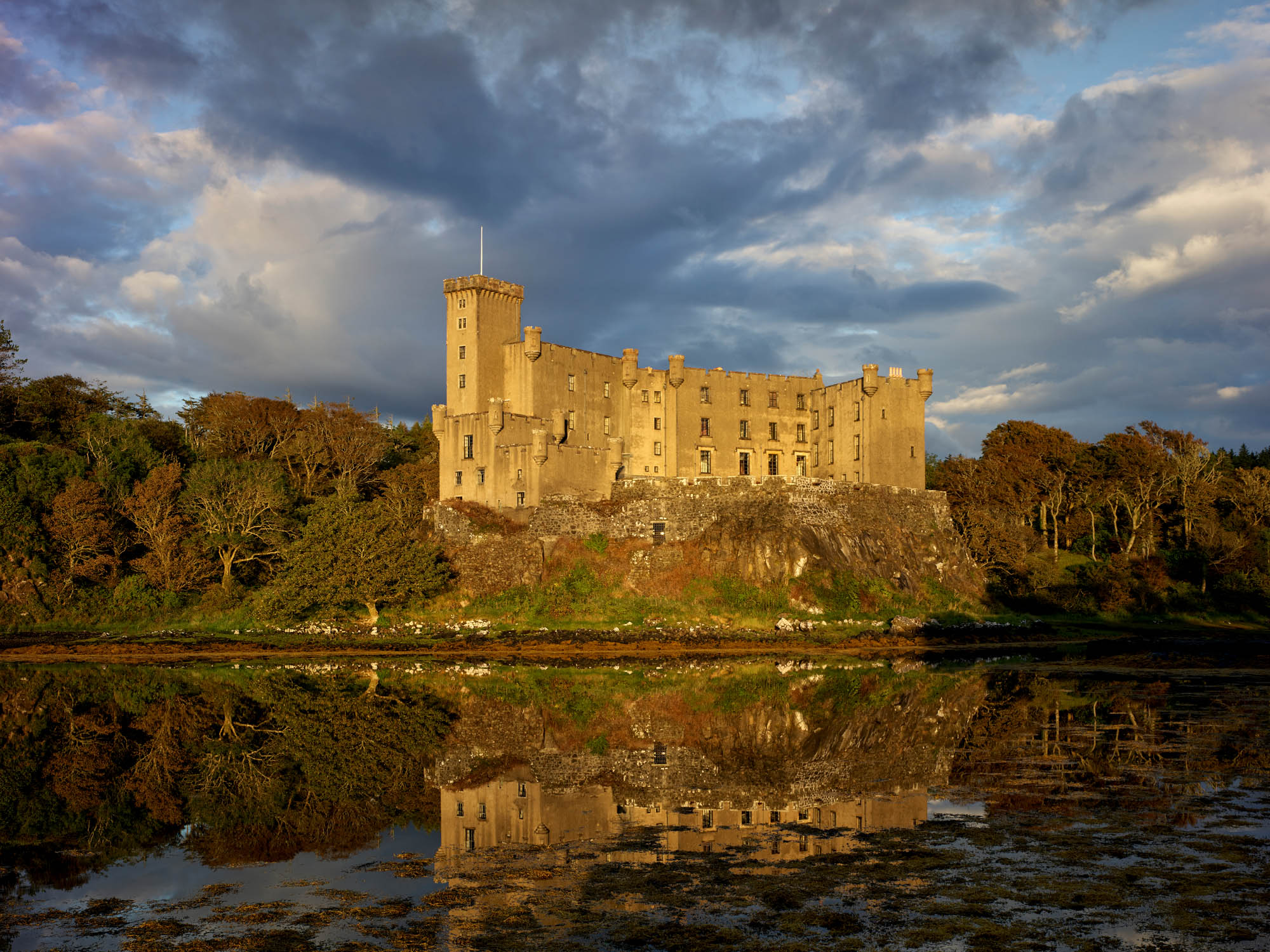 Fig 1: Dunvegan Castle, on the Isle of Skye, sits atop an outcrop of basalt rock, which is washed on the three sides by the tide. Castle from the west across inlet at sunset, Dunvegan Castle ©Paul Highnam for Country Life