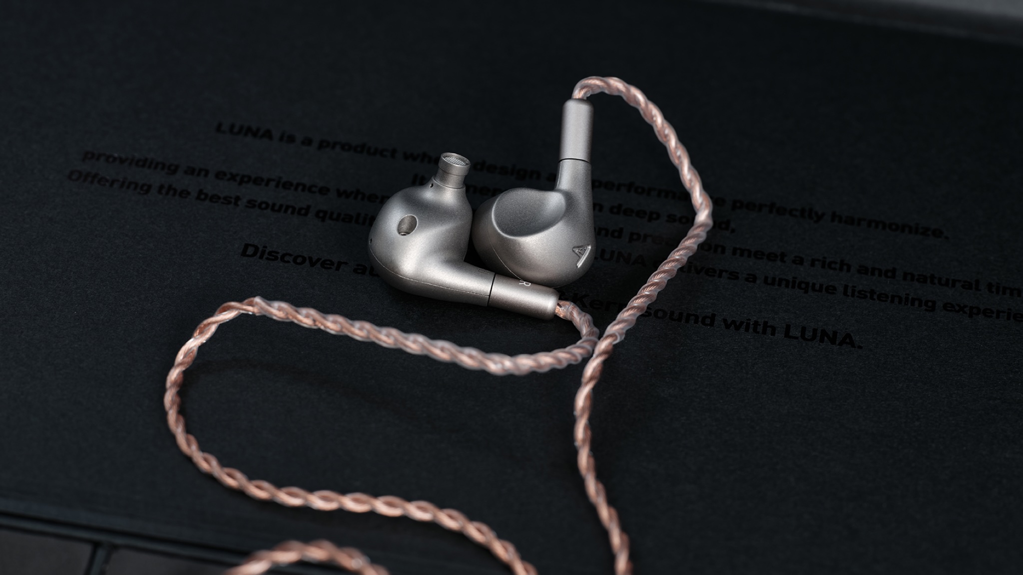 A pair of Astell & Kern Luna IEMs on a black background
