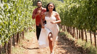 Regé-Jean Page and Halle Bailey running through the fields in You, Me & Tuscany.