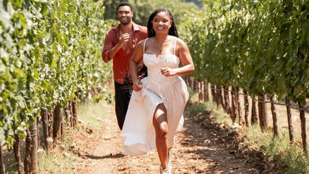 Reg&eacute;-Jean Page and Halle Bailey running through the fields in You, Me & Tuscany.