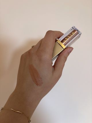 Mica Ricketts showing swatch of Stila Glitter & Glow Liquid Eye Shadow Rose Gold Retro