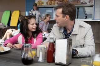 imogen faith reid as natalia grace and mark duplass as michael barnett eating outdoors as at a restaurant in a still from good american family