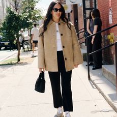 nicole eshaghpour outfit photo in beige suede jacket and sneakers