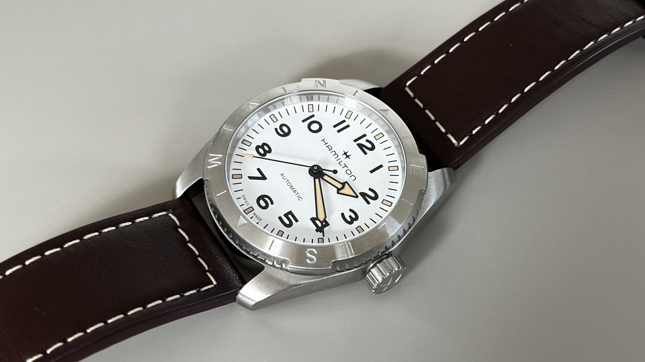 The Hamilton Khaki Field Expedition with a white dial on a grey background