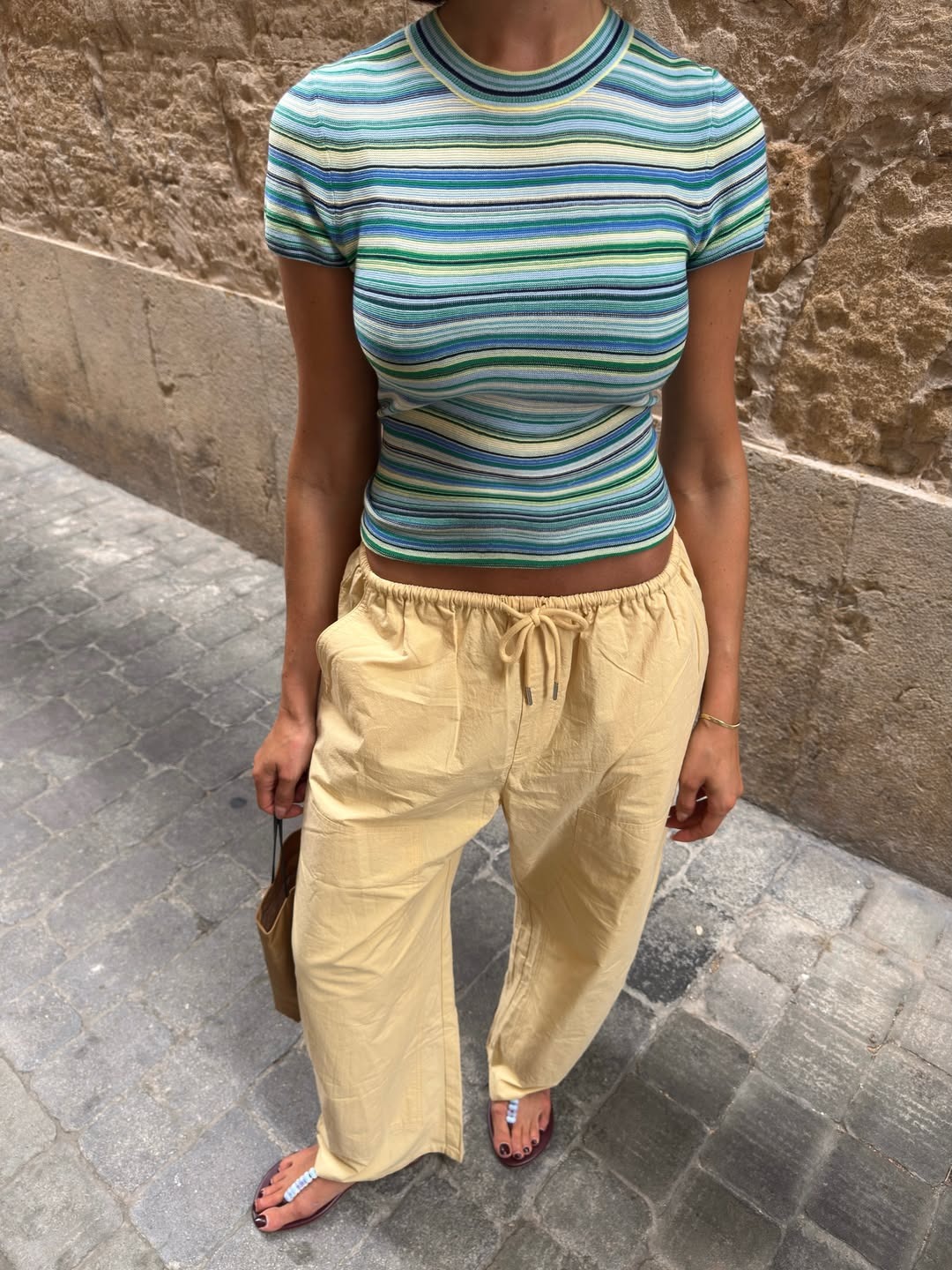 @smythesisters wearing drawstring pants and a crewneck
